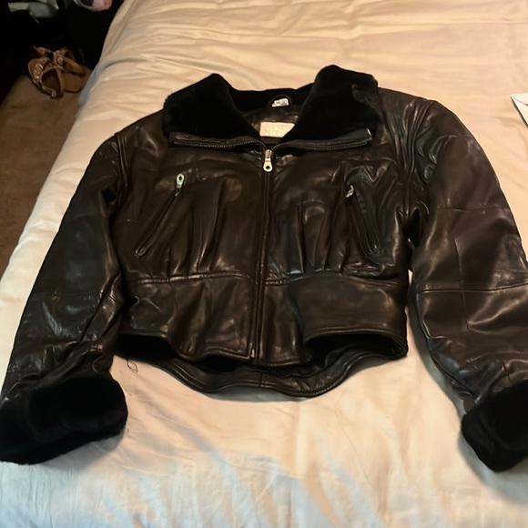 Thick and cozy black leather jacket with fur around the color and wrists. - Picture 2 of 4